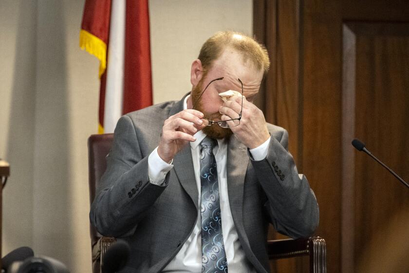 Travis McMichael reacts to questions during his testimony in the trial of he and his father Greg McMichael and neighbor William "Roddie" Bryan in the Glynn County Courthouse, Wednesday, Nov. 17, 2021, in Brunswick, Ga. The three are charged with the February 2020 slaying of 25-year-old Ahmaud Arbery. (AP Photo/Stephen B. Morton, Pool)