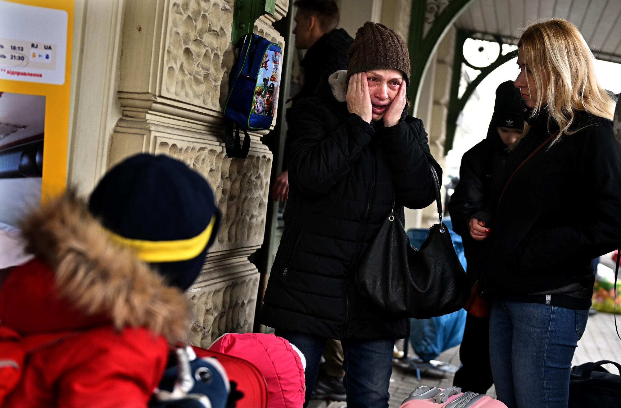 A Ukrainian refugee cries.