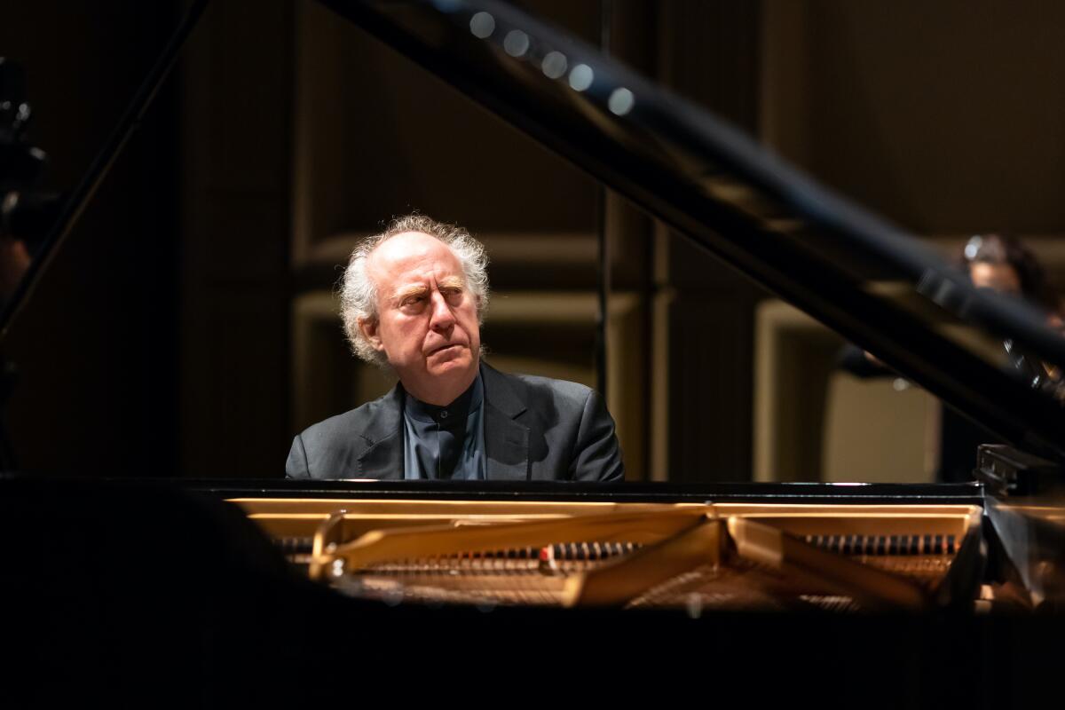 A man sits at a piano.