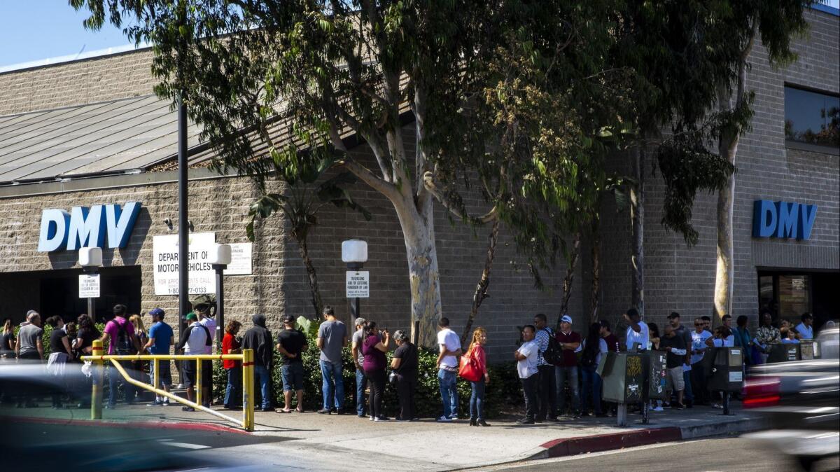 A line of people wait to be helped at a California Department of Motor Vehicles Office stretches around the building at the South LA location on Aug. 7, 2018.