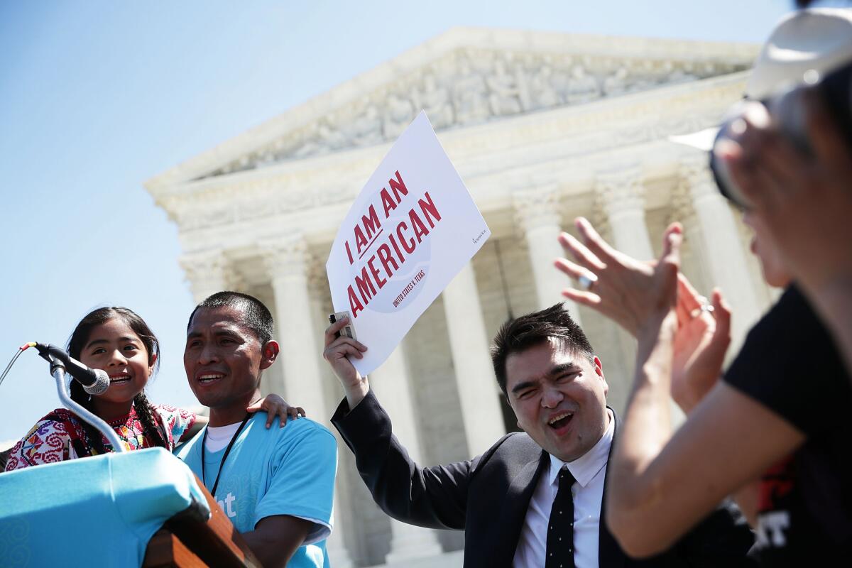 Six-year-old Sophie Cruz, left, speaks during a rally in front of the U.S. Supreme Court next to her father Raul Cruz and supporter Jose Antonio Vargas, who came to the United States illegally as a child. Vargas previously worked with the Los Angeles Times.