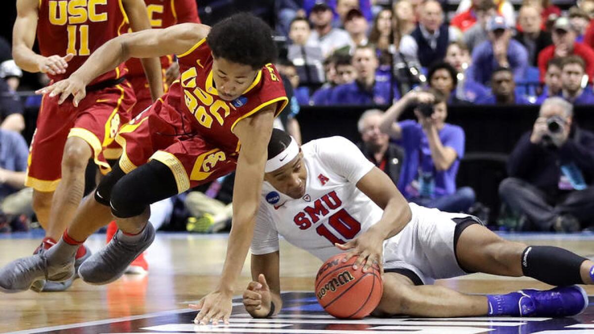 USC guard Elijah Stewart tries to grab a loose ball from SMU guard Jarrey Foster during the second half.
