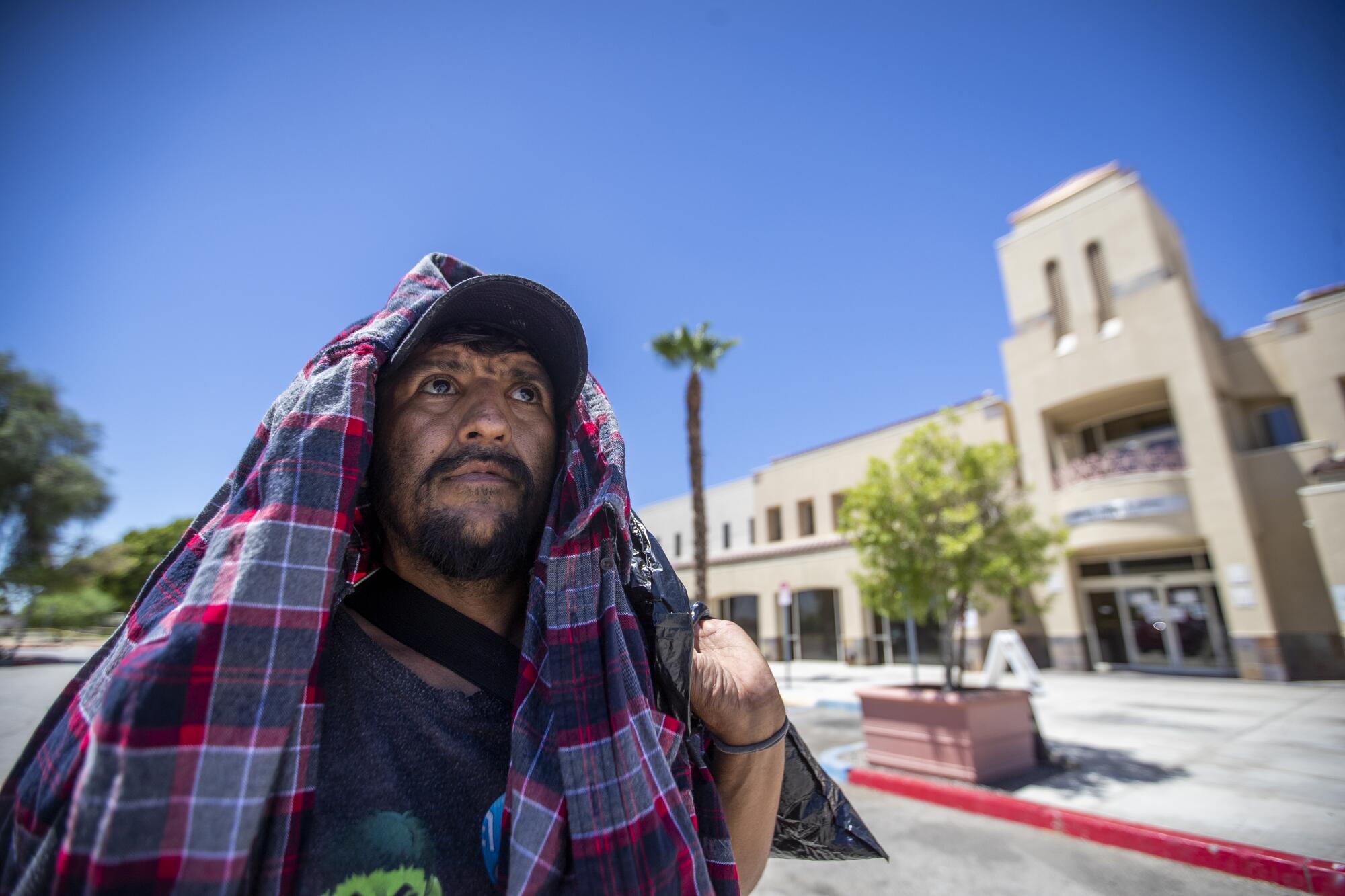 Osmani Ramirez, 41, homeless for four years, in 109-degree heat in Indio as he walks to a cooling station.