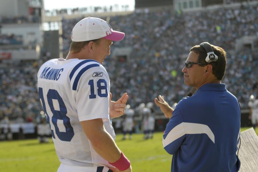 Indianapolis Colts quarterback Peyton Manning (18) talks with Jacksonville Jaguars offensive coordinator Clyde Christensen during an NFL football game in Jacksonville, Fla., Sunday, Sept. 3, 2010.(AP Photo/Phelan M. Ebenhack)