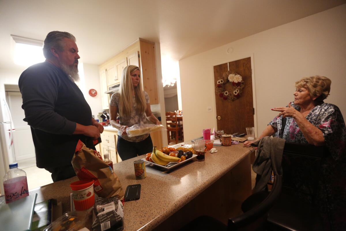 Tom and Shelly Lanning, from left, talk with Lanning's mother, Jeannie Anderson, on Oct.17, 2017. The Lannings have been staying with Anderson since they lost their home in wildfires.