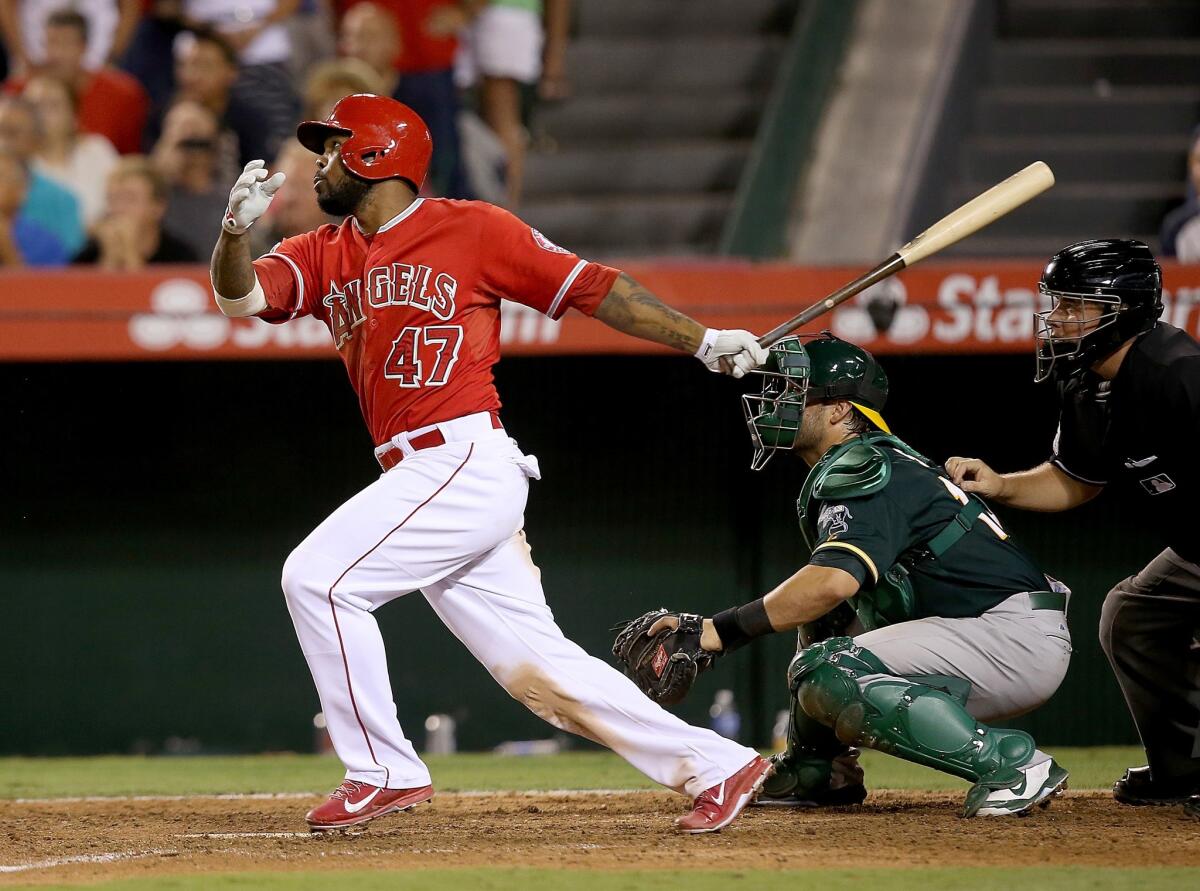 Howie Kendrick hits a sacrifice fly to score Albert Pujols in the 10th inning of the Angels' win over the Athletics, 4-3.