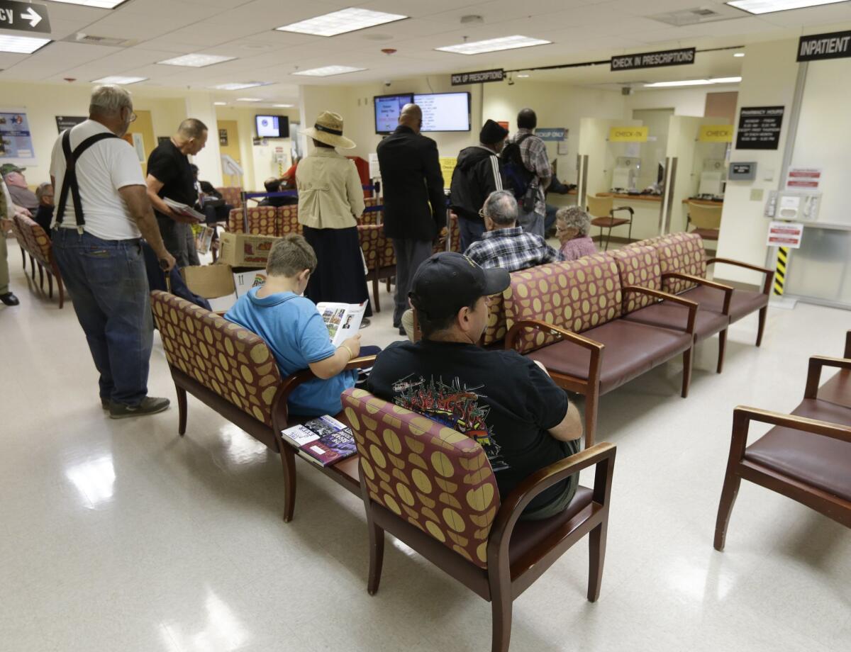 People line up to get prescriptions filled at the pharmacy in the Sacramento Veterans Affairs Medical Center in Rancho Cordova April 2.