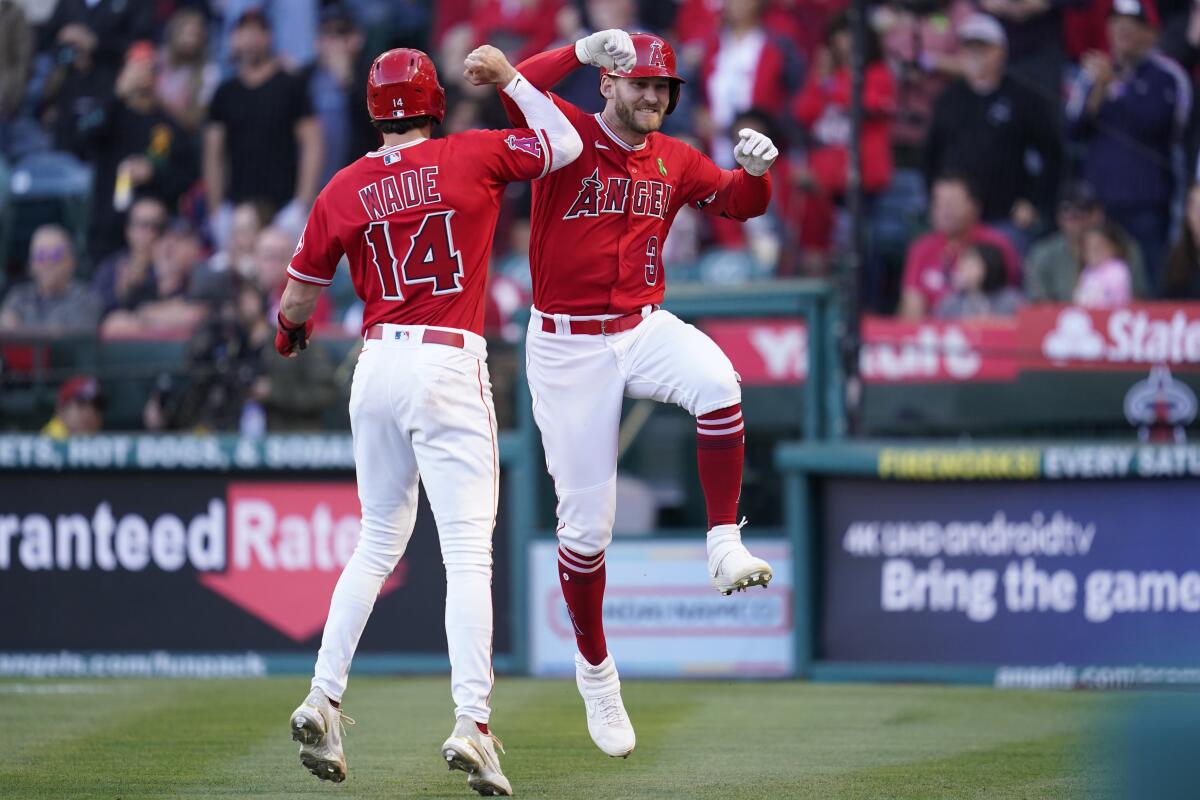 Angels' Taylor Ward celebrates with Tyler Wade after they both scored off of a home run hit by Ward.