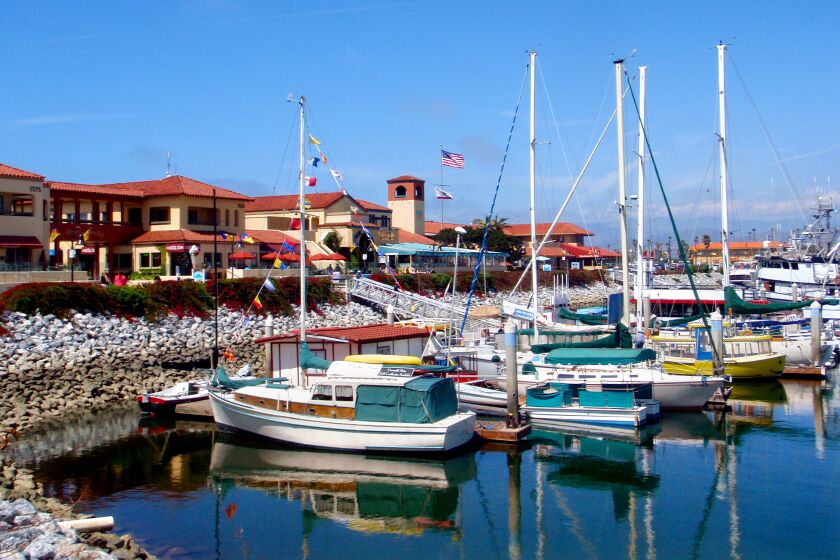 Ventura Harbor reflects the boats with a floating B&B inthe foreground.