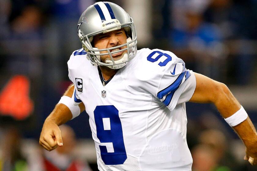 Quarterback Tony Romo reacts after the Cowboys scored a touchdown against the Lions in the second half Sunday.