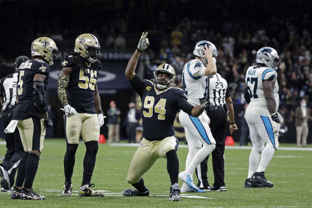 New Orleans Saints defensive end Cameron Jordan (94) celebrates his sack of Carolina Panthers quarterback Sam Darnold as Darnold walks to the sideline in the second half of an NFL football game in New Orleans, Sunday, Jan. 2, 2022. The Saints won 18-10. (AP Photo/Derick Hingle)