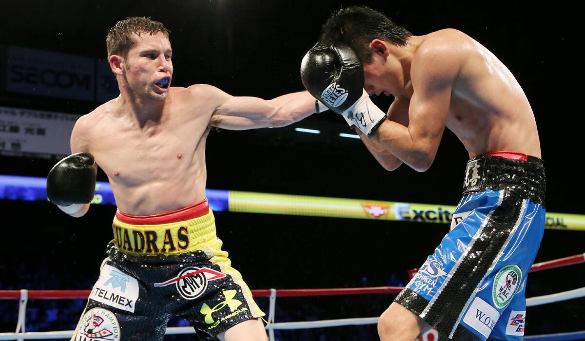 Mexican champion Carlos Cuadras, left, lands a left to the head of Koki Eto during their WBC super-flyweight title bout on Nov. 28, 2015.