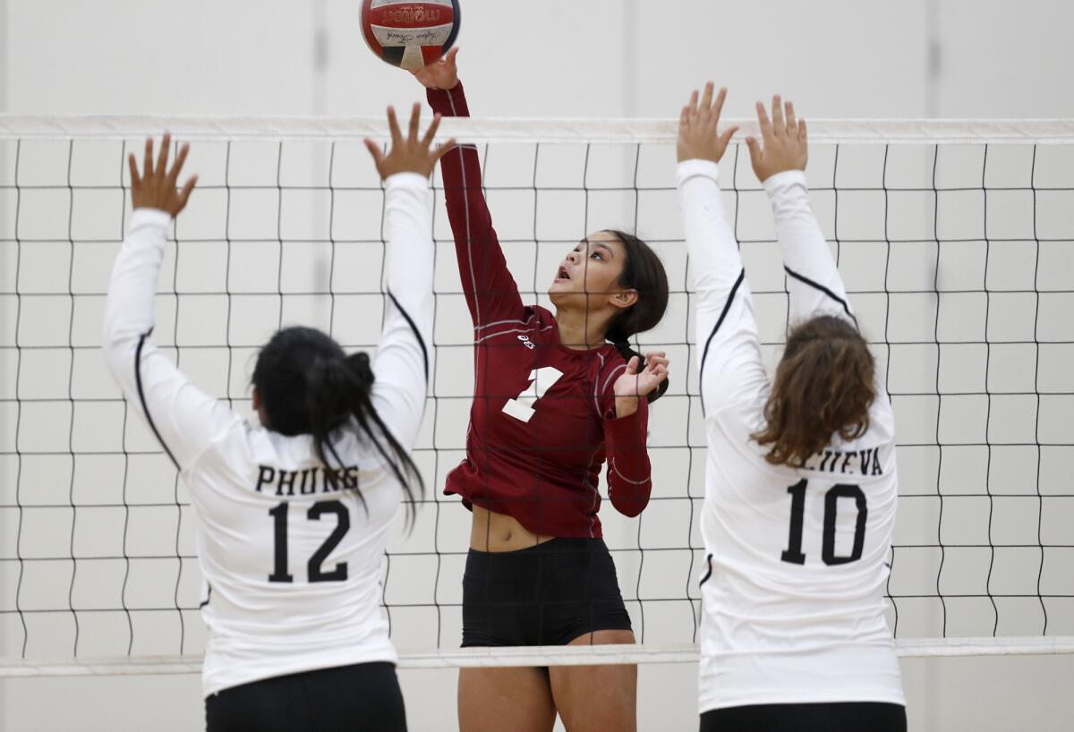 Estancia's Sydney Bilderback (1) battles at the net in the first set against Bolsa Grande on Tuesday in a nonleague match.
