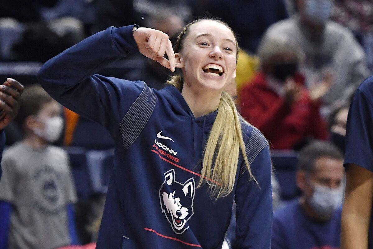 Connecticut's Paige Bueckers reacts after teammates Caroline Ducharme blocked a shot against Creighton in the first half of an NCAA college basketball game, Sunday, Jan. 9, 2022, in Storrs, Conn. (AP Photo/Jessica Hill)