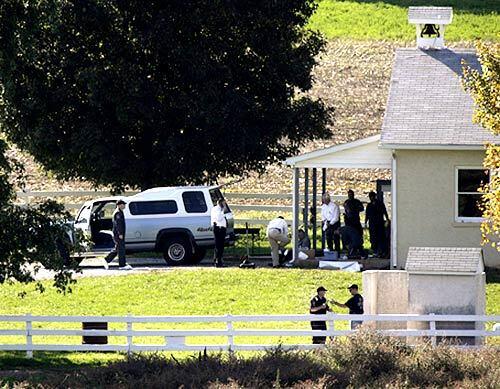 Investigators are seen at a schoolhouse where a gunman went on a rampage, killing at least three girls and himself.