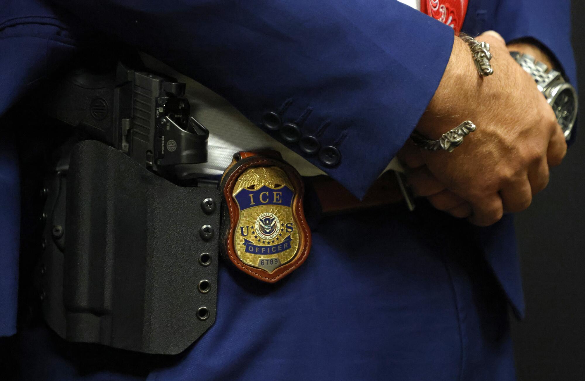 A detailed view of the badge worn by the deputy assistant director of ICE field operations.