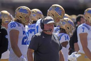 UCLA head coach Chip Kelly looks on from the sidelines during the first half of an NCAA.