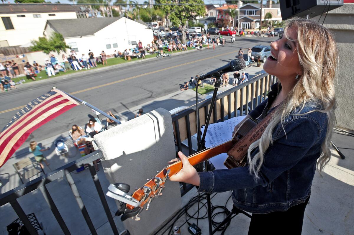 Brennley Brown, 18, performs from the balcony of her home for a large crowd in Huntington Beach on May 22.