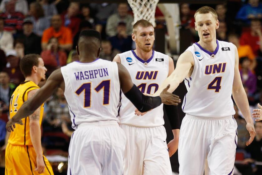 Northern Iowa's Paul Jesperson (4) and Wes Washpun (11) celebrate during a game against Wyoming in the second round of the NCAA tournament.