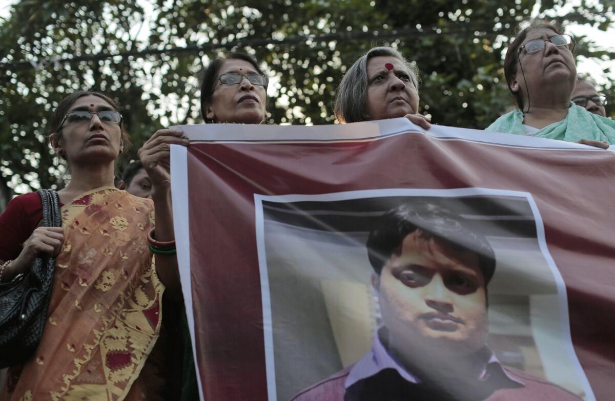 Bangladeshi social activists hold a banner displaying a portrait of blogger and author Ananta Bijoy Das during a protest in Dhaka on Monday against his killing.
