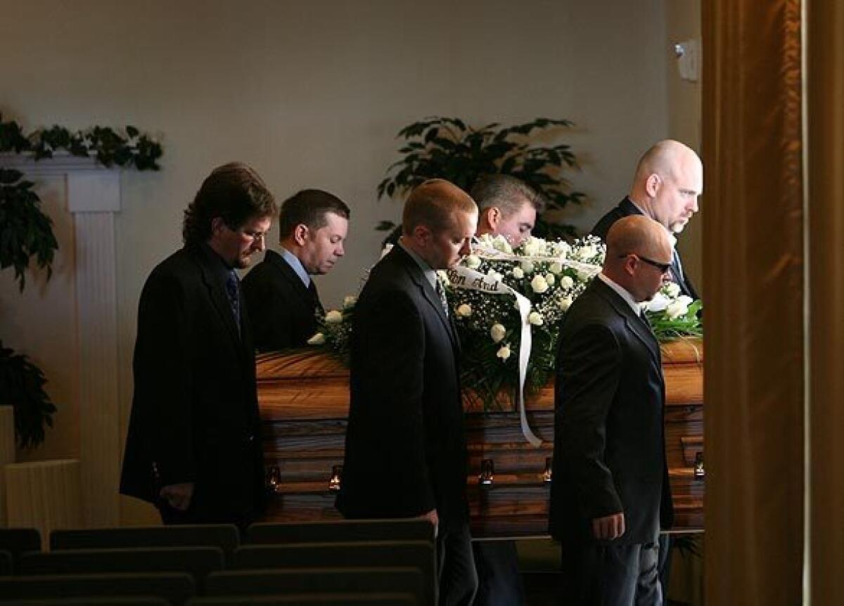 Christopher Aiken's brothers and close childhood friends serve as pallbearers at his funeral Saturday morning. The chapel was overflowing as dozens turned out to remember him at Conejo Mountain Memorial Park.