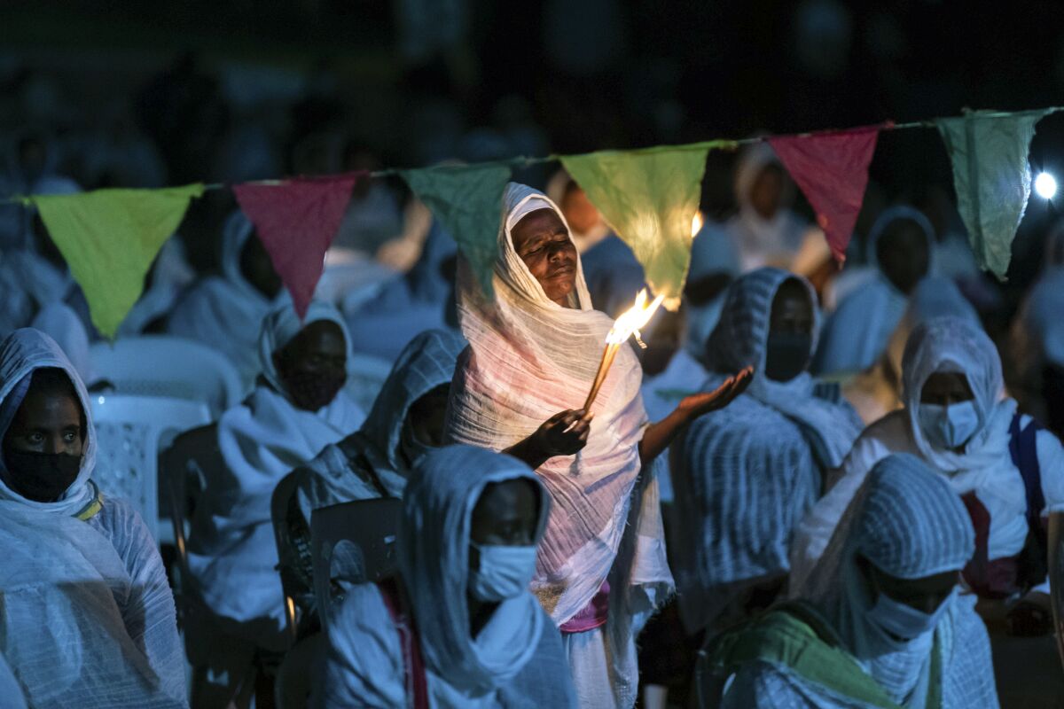 Ethiopian Orthodox Christians light candles and pray for peace.