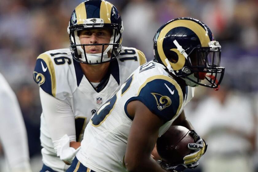 Rams quarterback Jared Goff hands the ball off to running back Rohan Gaines during the first quarter of a game on Sept. 1.