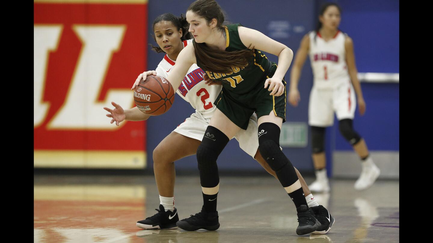 Los Alamitos' Asia Avinger attempts to steal the ball from Edison's Gabby Samiy during a Sunset League game on Tuesday, January 30.