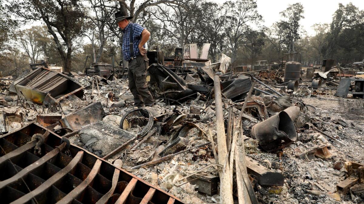 Ed Bledsoe surveys his home and belongings destroyed by the Carr in Redding.