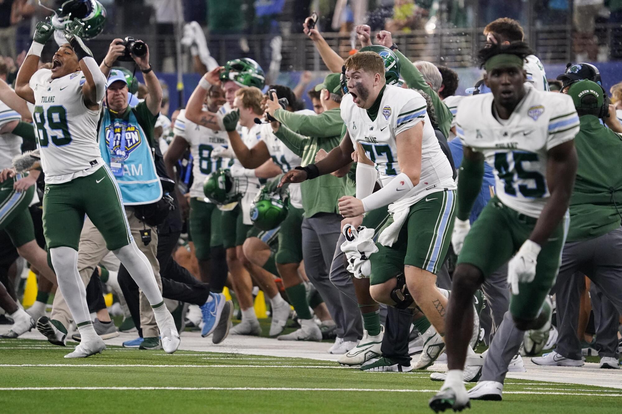 Tulane players and coaches celebrate immediately after defeating USC in the Cotton Bowl.