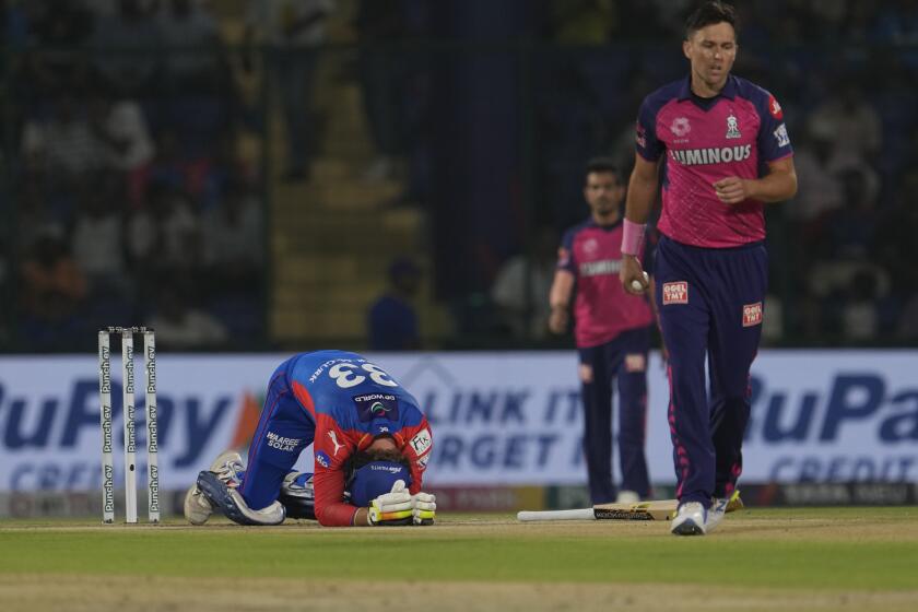 Delhi Capitals' Jake Fraser-McGurk reacts after getting hurt on a delivery by Rajasthan Royals' Trent Boult during the Indian Premier League cricket match between Delhi Capitals and Rajasthan Royals in New Delhi, India, Tuesday, May 7, 2024. (AP Photo/Manish Swarup)