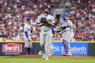 Los Angeles Dodgers pitcher Yohan Ramírez, center, leaves after a pitching change.