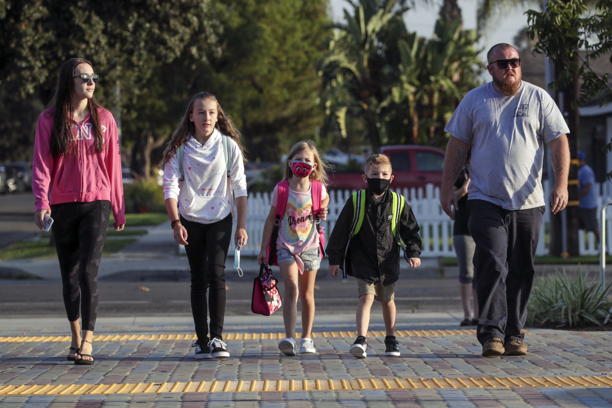 A family walks to Theodore Roosevelt Elementary School.