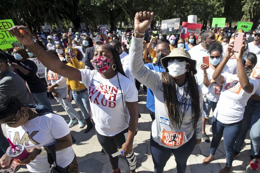 People react during a rally to protest the shooting of Ahmaud Arbery, an unarmed black man, Friday, May 8, 2020, in Brunswick Ga. Two men have been charged with murder in the February shooting death of Arbery, whom they had pursued in a truck after spotting him running in their neighborhood. (AP Photo/John Bazemore)