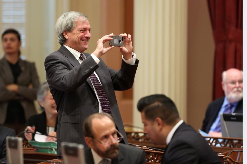 Then-state Sen. Mark DeSaulnier, D-Concord, takes a photo during the 2014 Senate session. DeSaulnier was diagnosed with leukemia shortly after being elected to Congress.