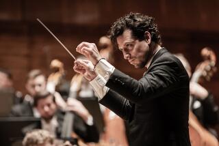 Conductor Paolo Bortolameolli conducts an orchestra.