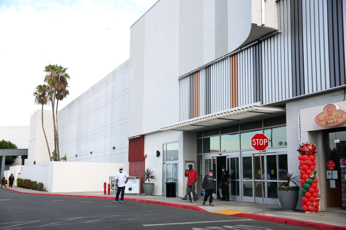 Shoppers exit the Baldwin Hills Crenshaw Mall on Dec. 8, 2020. 