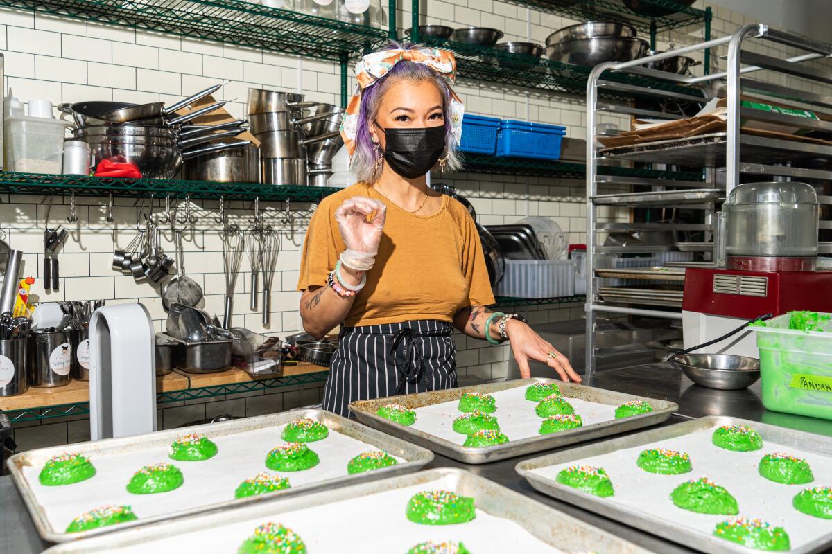 A woman prepares green biscuits