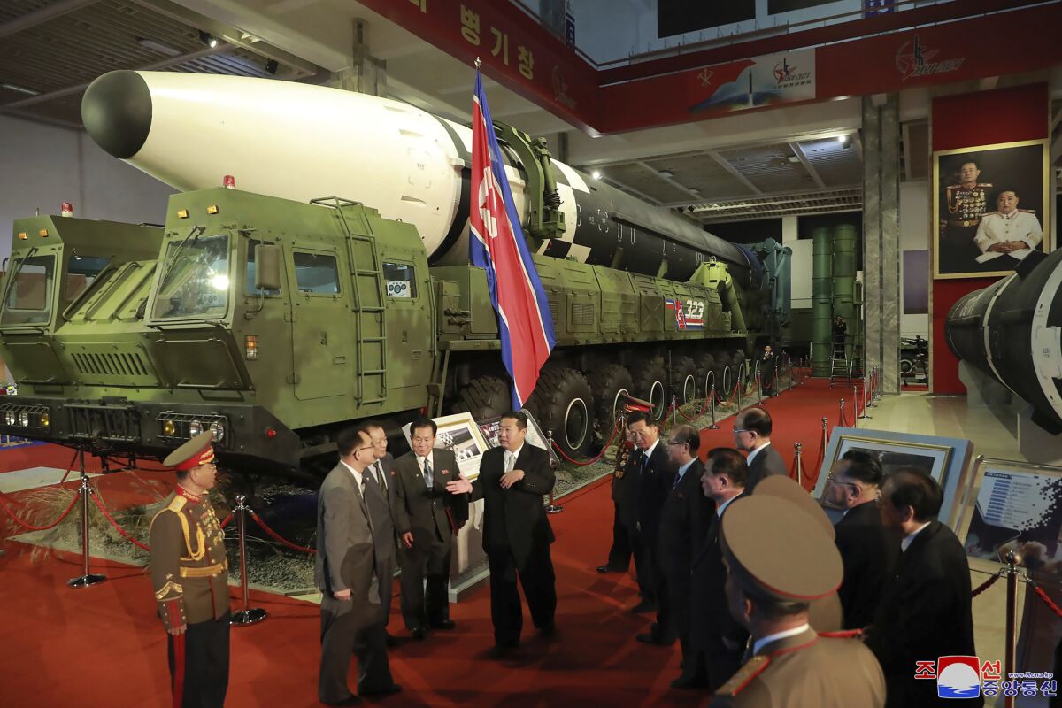 In this photo provided by the North Korean government, North Korean leader Kim Jong Un, center, speaks in front of what the North says an intercontinental ballistic missile displayed at an exhibition of weapons systems in Pyongyang, North Korea, Monday, Oct. 11, 2021. Kim reviewed the rare exhibition and vowed to build an “invincible” military, as he accused the United States of creating regional tensions and lacking action to prove it has no hostile intent toward the North, state media reported Tuesday. Independent journalists were not given access to cover the event depicted in this image distributed by the North Korean government. The content of this image is as provided and cannot be independently verified. Korean language watermark on image as provided by source reads: "KCNA" which is the abbreviation for Korean Central News Agency. (Korean Central News Agency/Korea News Service via AP)