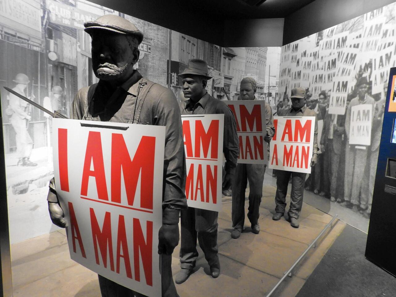 In a museum exhibit detailing the 1968 strike by Memphis garbagemen, models of the sanitation workers hold placards that read, “I Am a Man,” the battle cry of their successful effort to organize a union.