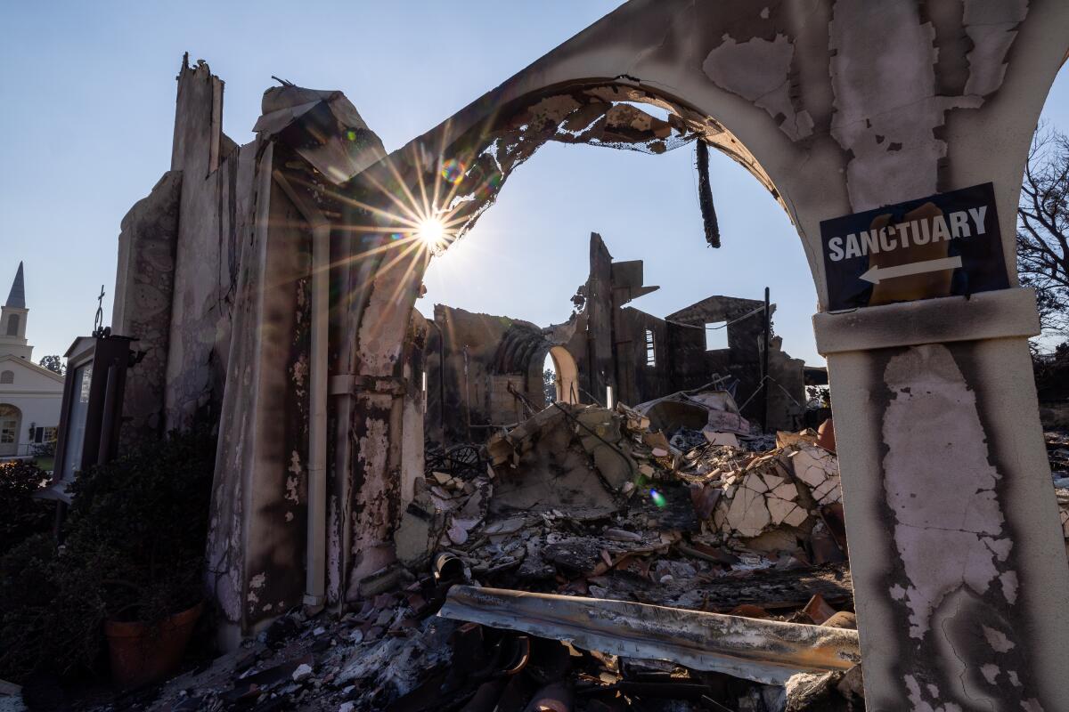 The evening sun shines through the scorched remains of the Altadena Community Church on Jan. 11, 2025.
