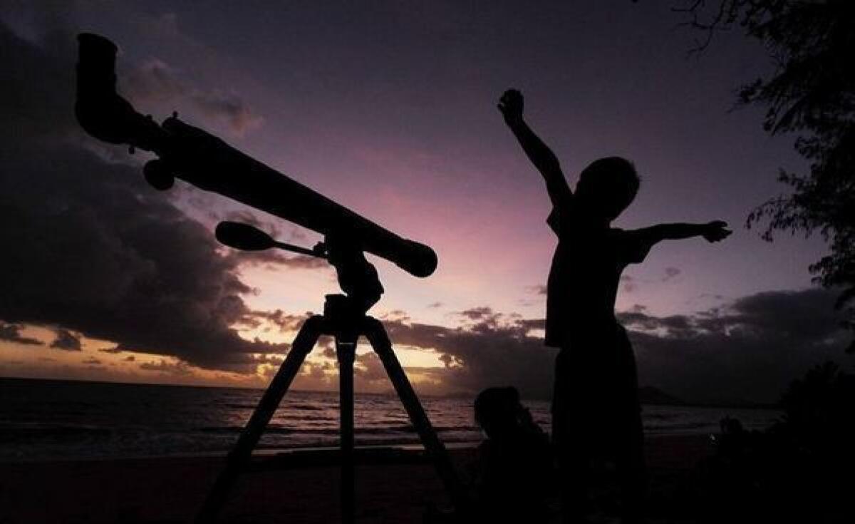 A young boy gets ready to view the solar eclipse with his telescope Nov. 14 in Palm Cove, Australia. Wednesday's penumbral lunar eclipse will be less dramatic.