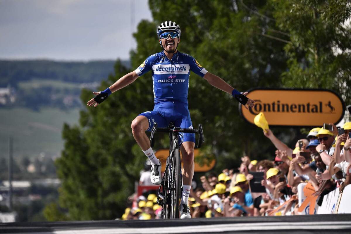 French rider Julian Alaphilippe celebrates his victory as he crosses the Stage 3 finish line of the Tour de France on Monday in Epernay, France.
