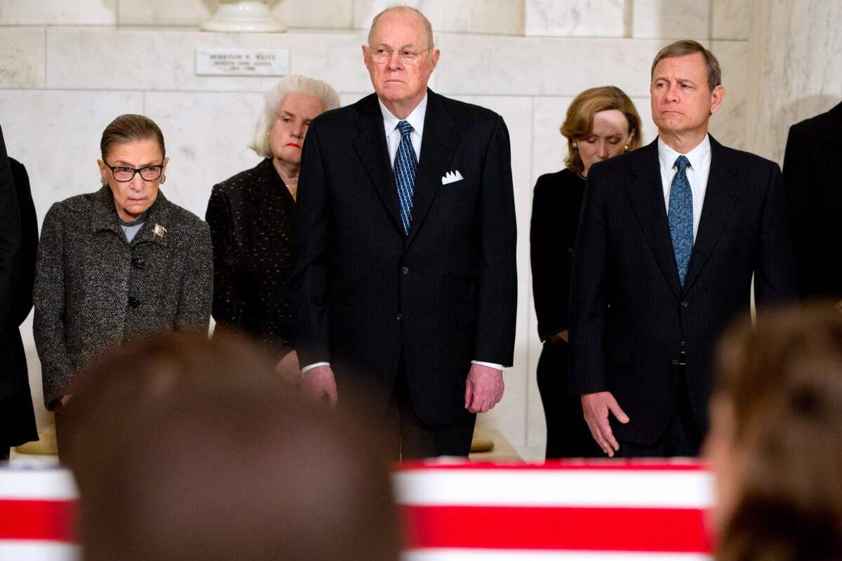 Supreme Court Justices Ruth Bader Ginsburg, Anthony M. Kennedy and Chief Justice John G. Roberts, Jr., attend a private ceremony in the Great Hall of the Supreme Court where late Supreme Court Justice Antonin Scalia lies in repose in Washington.