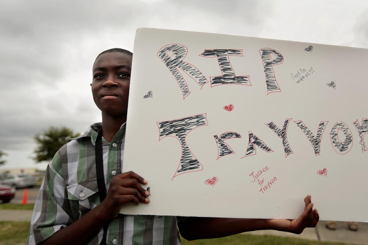 Jacarrio Williams, 10, of Orlando, came to Sanford, Fla., with his mother, Gloria Alcuis, and other family members to show support for Trayvon Martin after the acquittal of George Zimmerman, who stood trial in Martin's death.