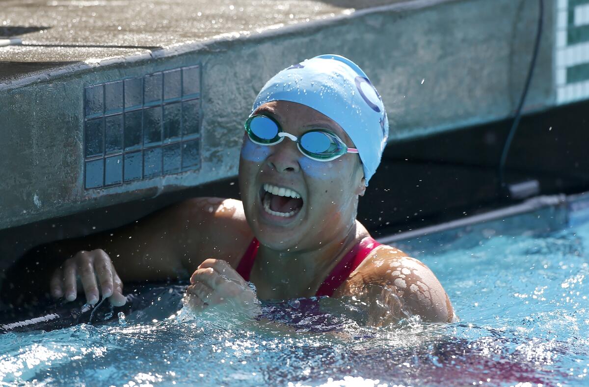Corona del Mar's Taylor Park yells in celebration after winning the girls' 200 free during the Surf League swim finals.
