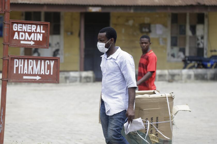 A man wearing face mask walks at the Yaba Mainland hospital were the first Nigerian victims of the COVID-19 virus are being treated in Lagos Nigeria Friday, Feb. 28, 2020. Nigeria's health authorities have reported the country's first case of a new coronavirus in Lagos, the first confirmed appearance of the disease in sub-Saharan Africa. (Photo/ Sunday Alamba)