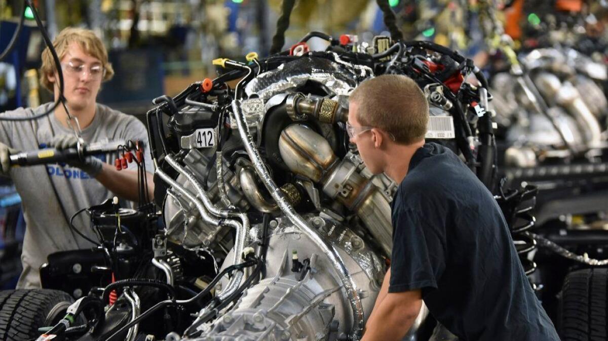 Production workers assemble a Ford F-Series truck at a plant in Louisville, Ky., in 2016.
