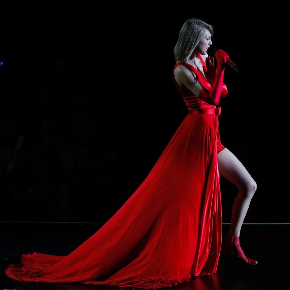 Taylor Swift shows some leg in this crimson gown as she performs in Shanghai in 2014.
