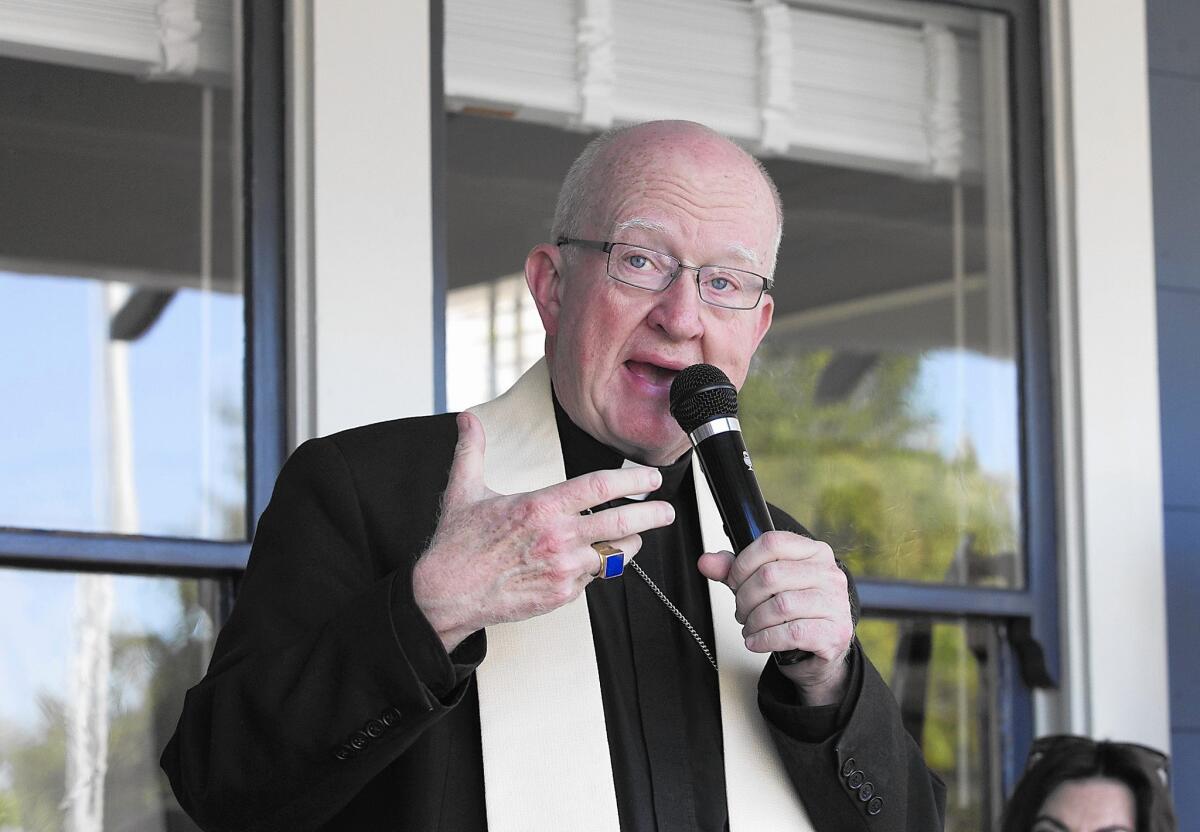 Bishop Kevin Vann blesses the new resale boutique store The Collection.